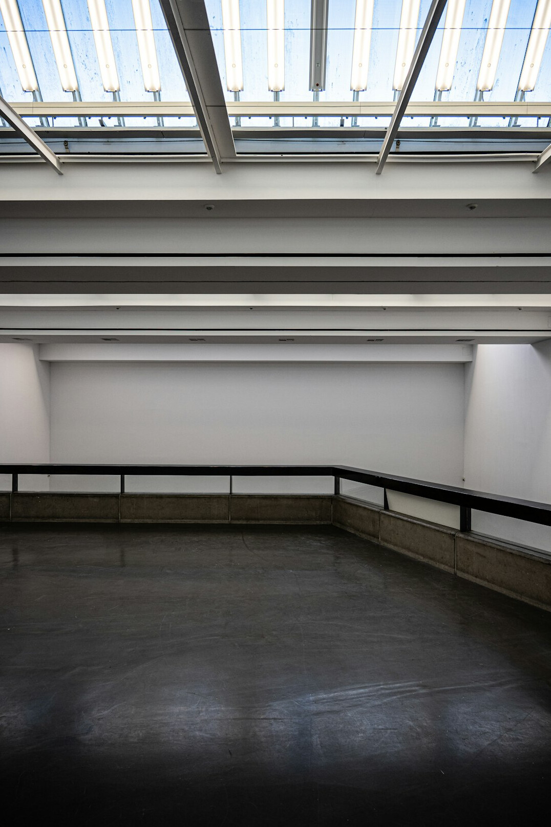 Empty museum gallery hall with soft overhead light