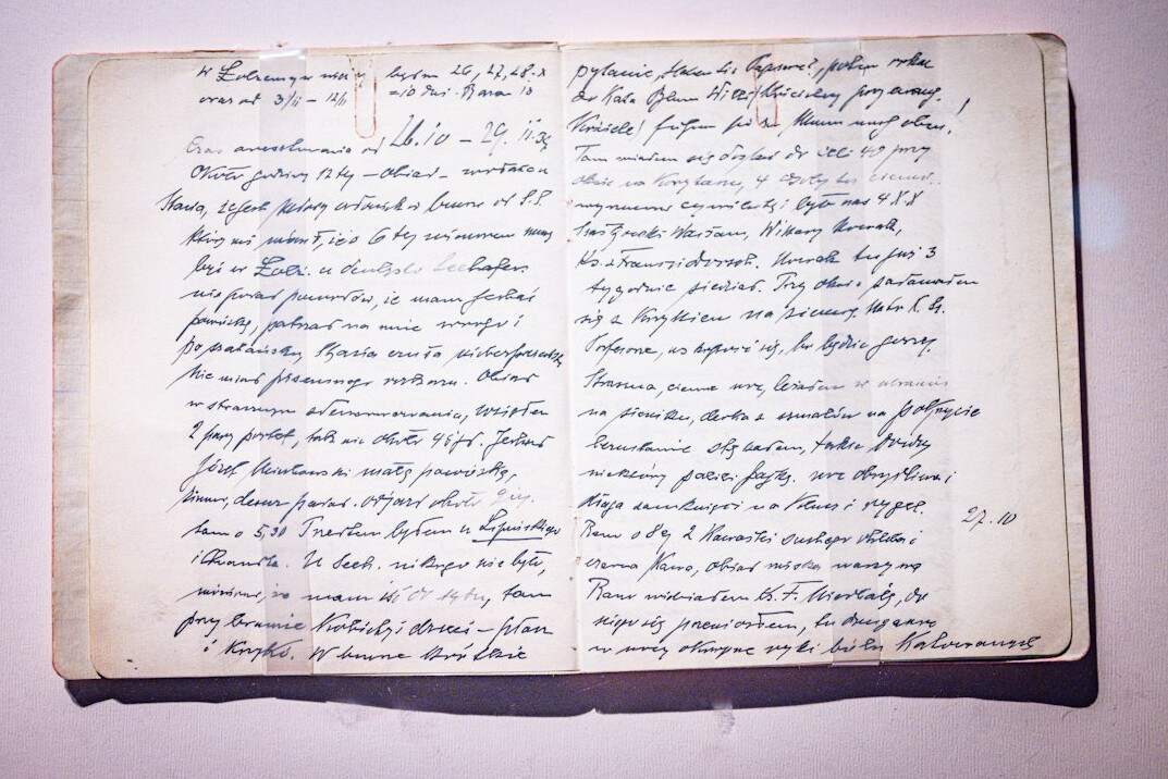 Stack of old archival documents and papers on a wooden desk